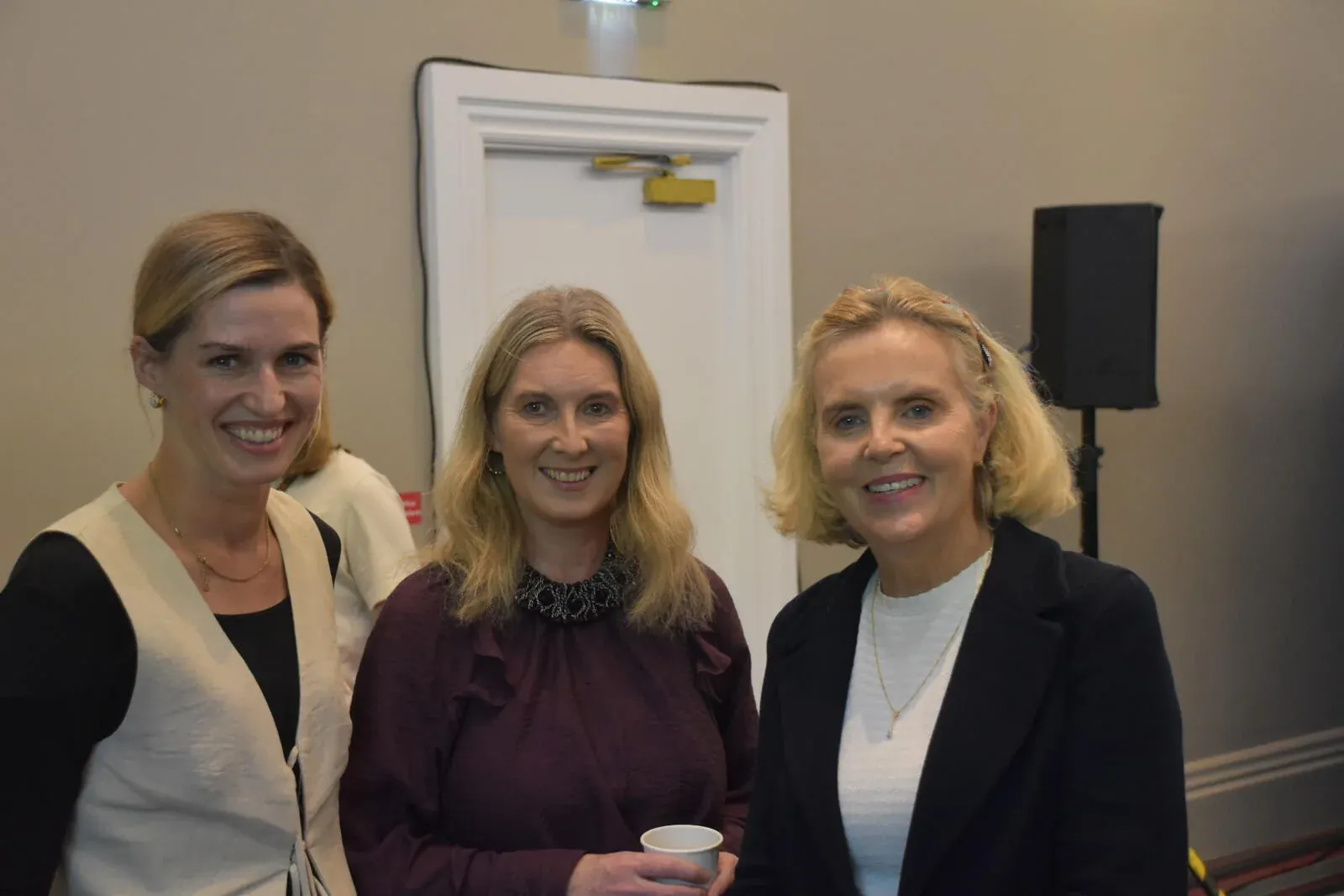Three members of the Society smiling together at the Annual Scientific Meeting